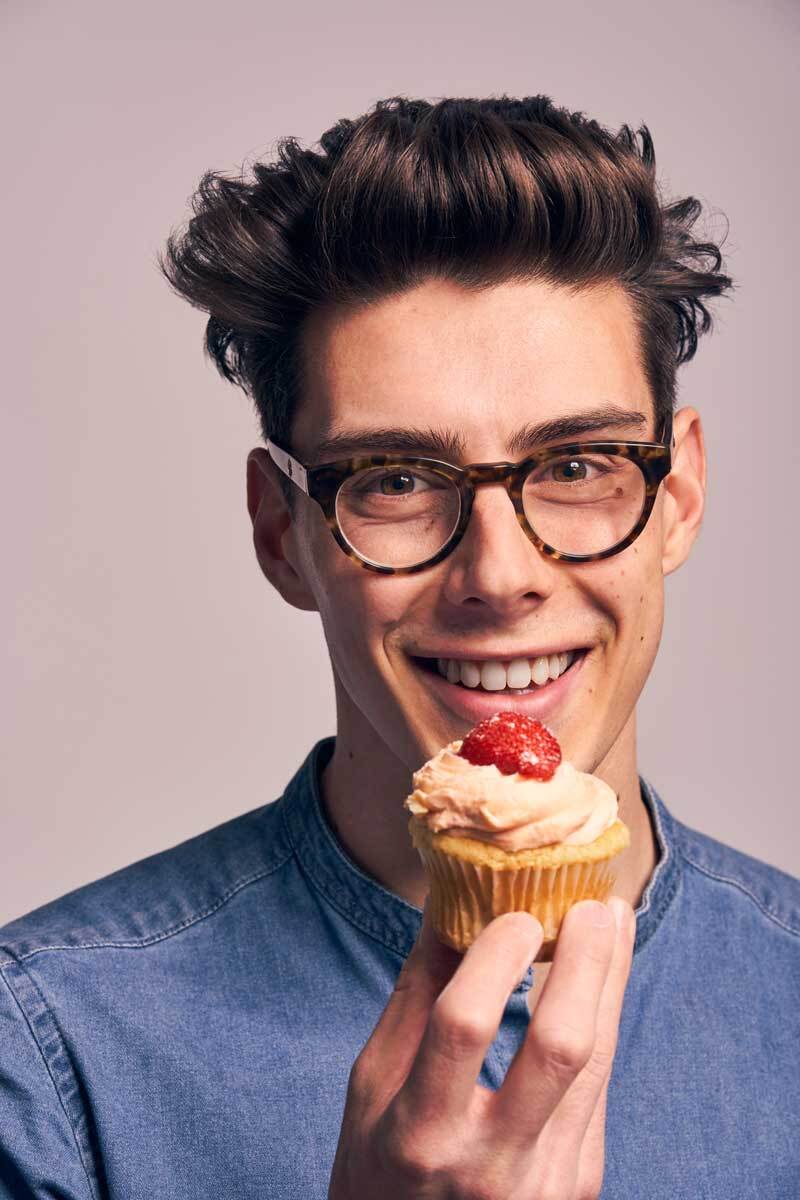 Matt Adlard holding a cupcake